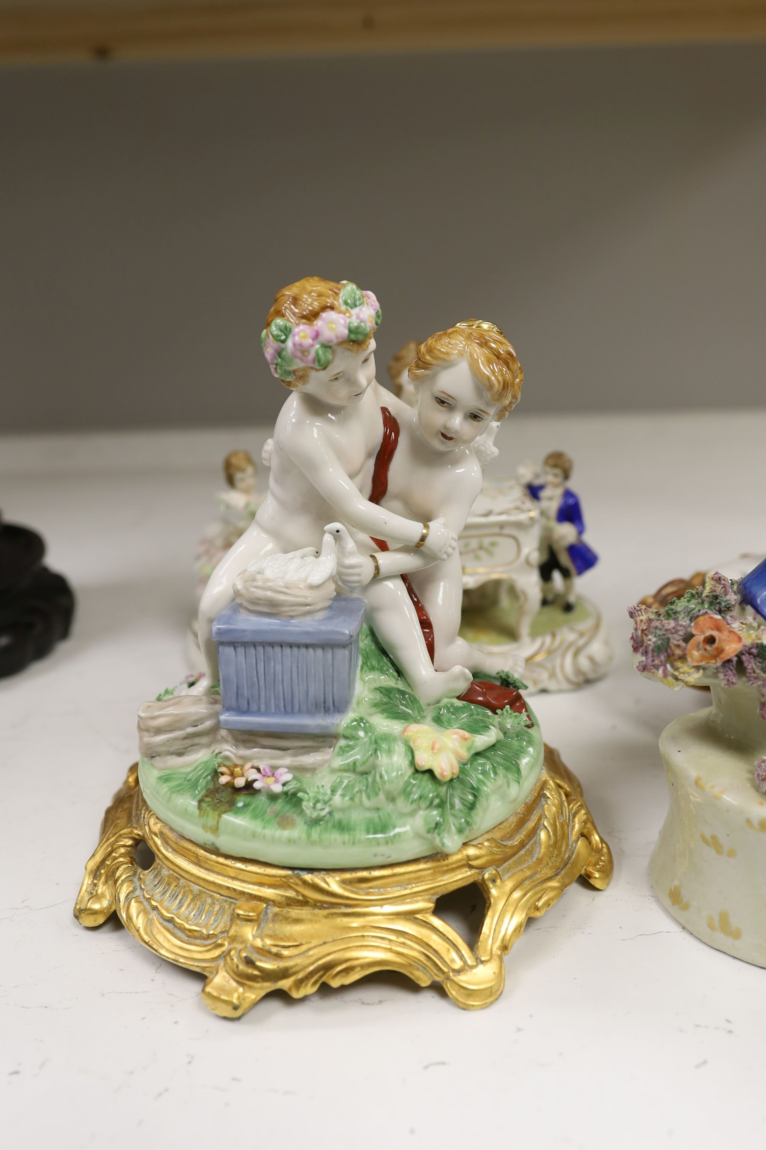 A John Bevington figural bowl, and four Continental porcelain groups and a Staffordshire style group, tallest 27cm